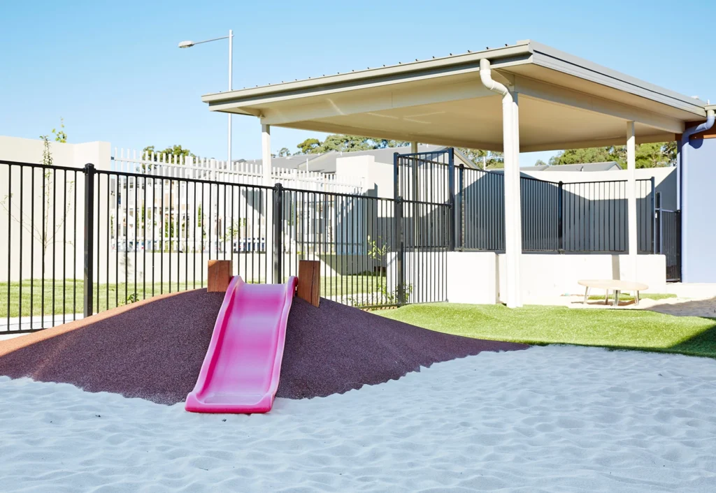 Nursery day care playground with sandpit and small slide