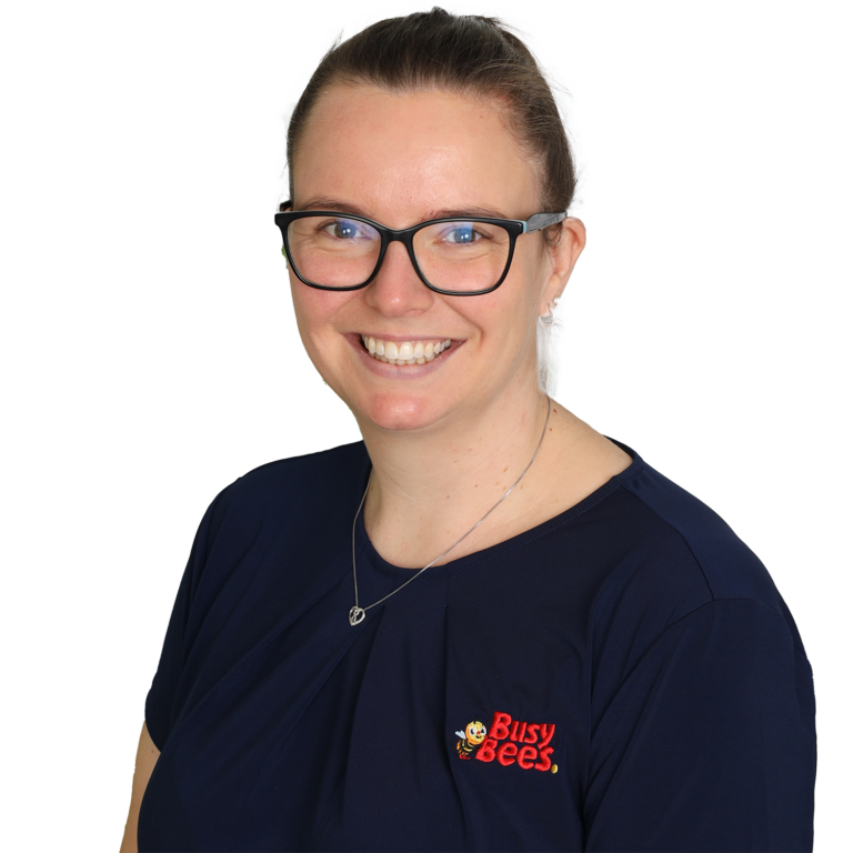 Person wearing glasses and a navy shirt with a "Busy Bees" logo, smiling at the camera.