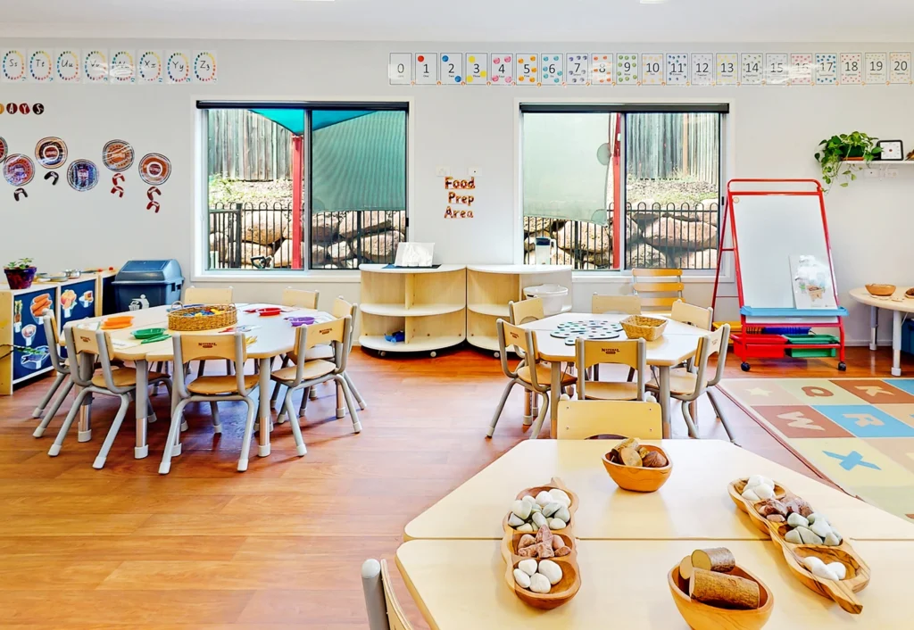 Underwood childcare offers a bright and well-organized classroom with tables filled with educational activities including loose parts play.