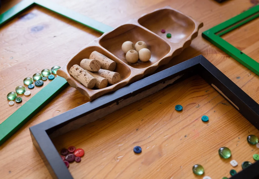 Loose parts play setup at Balcatta child care, featuring an assortment of buttons, corks, and beads.