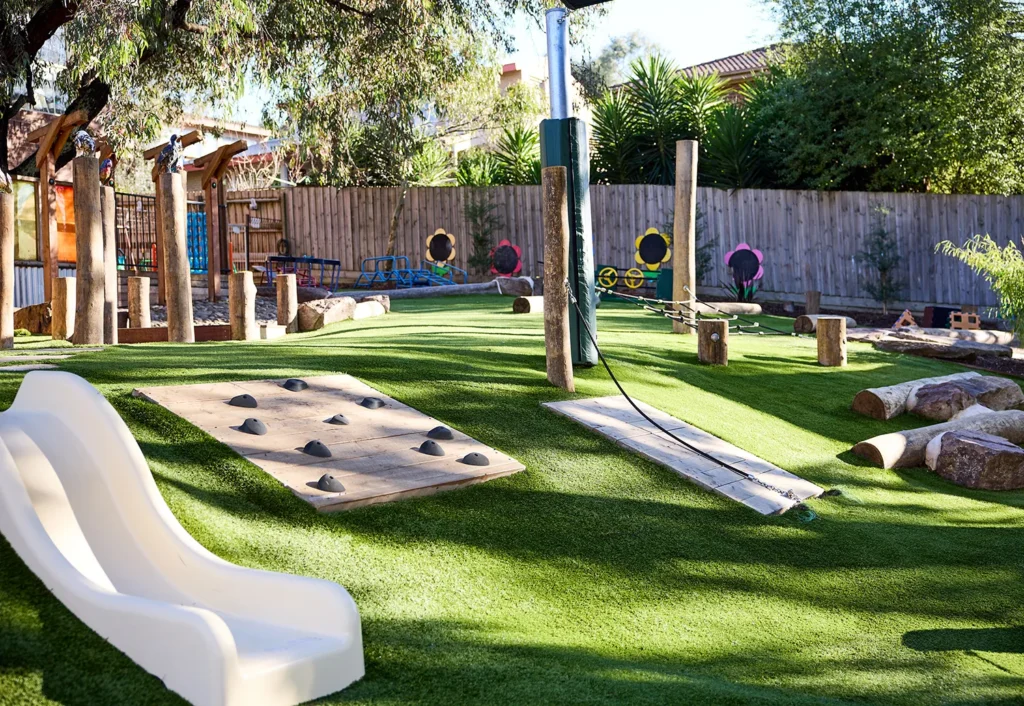 Doncaster East kindergarten playground featuring a slide and climbing activities.