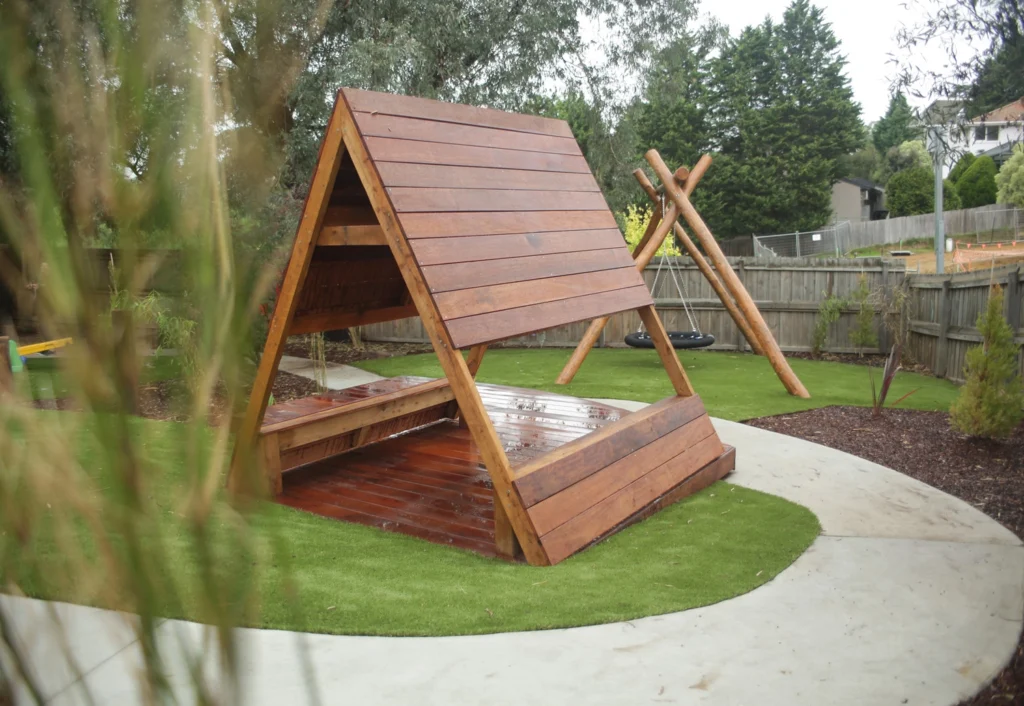 A timber triangle cubby house at Doncaster East kindergarten.