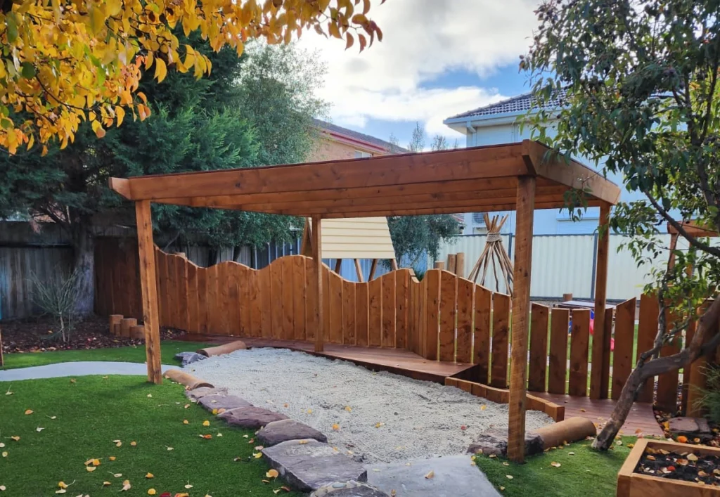 A sandpit with timber shade cover at Epping childcare centre.