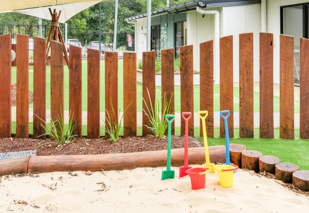 Sandpit with colourful buckets and shovels at Central Coast day care.