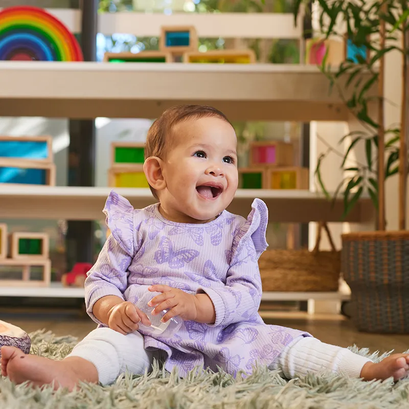 Baby sitting on fluffy rug