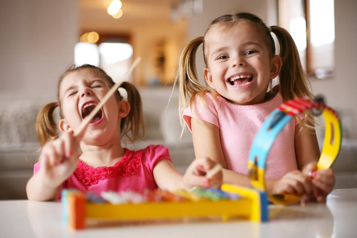 Kindergarten girls smiling with musical instruments