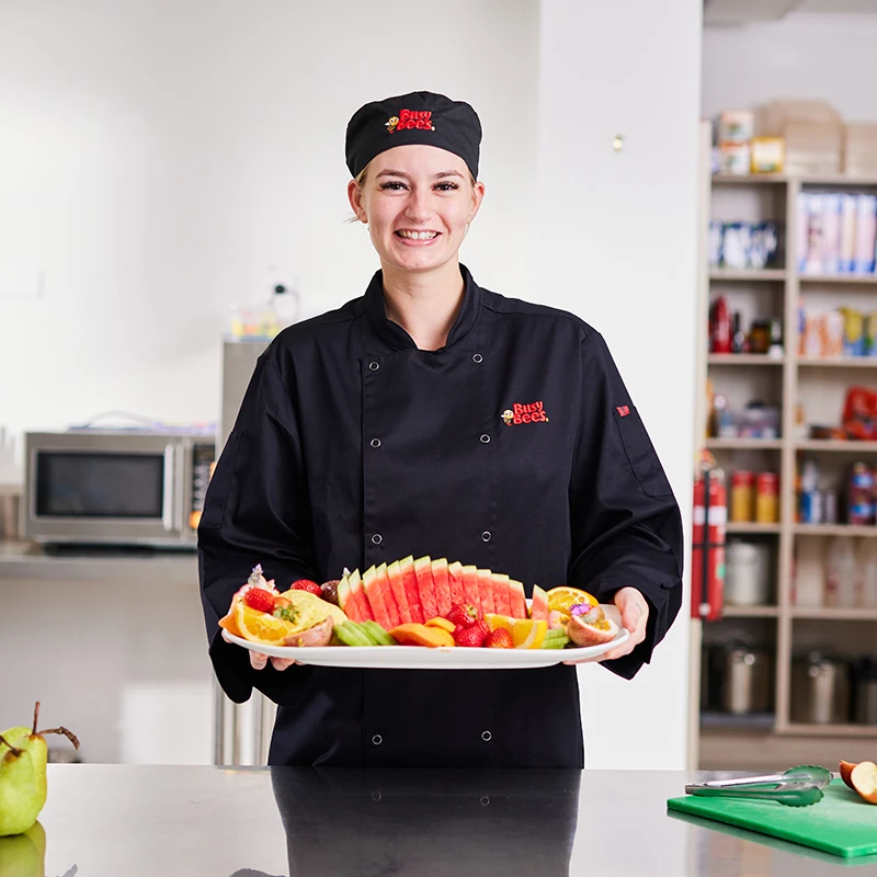 Chef holding a tray of fruit