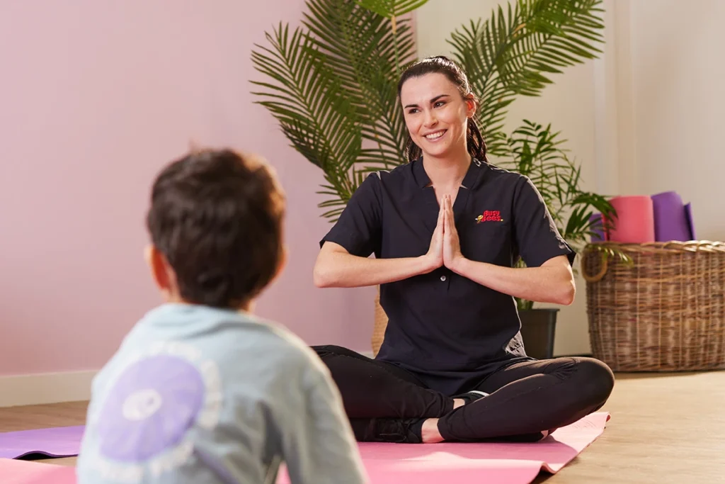 Educator and child doing yoga