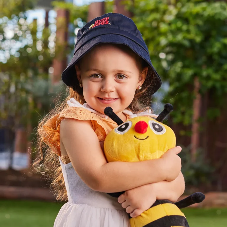 Kindergarten girl hugging a soft toy